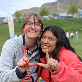 Two students showing the U